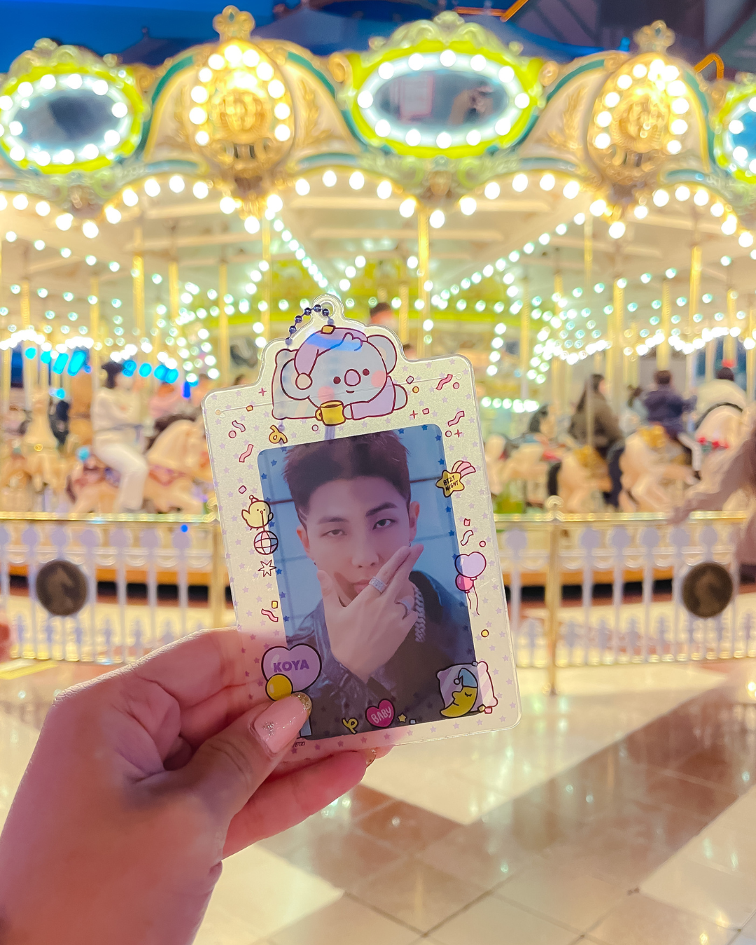 BTS RM Namjoon photocard held up at the Lotte World carousel in Seoul Korea