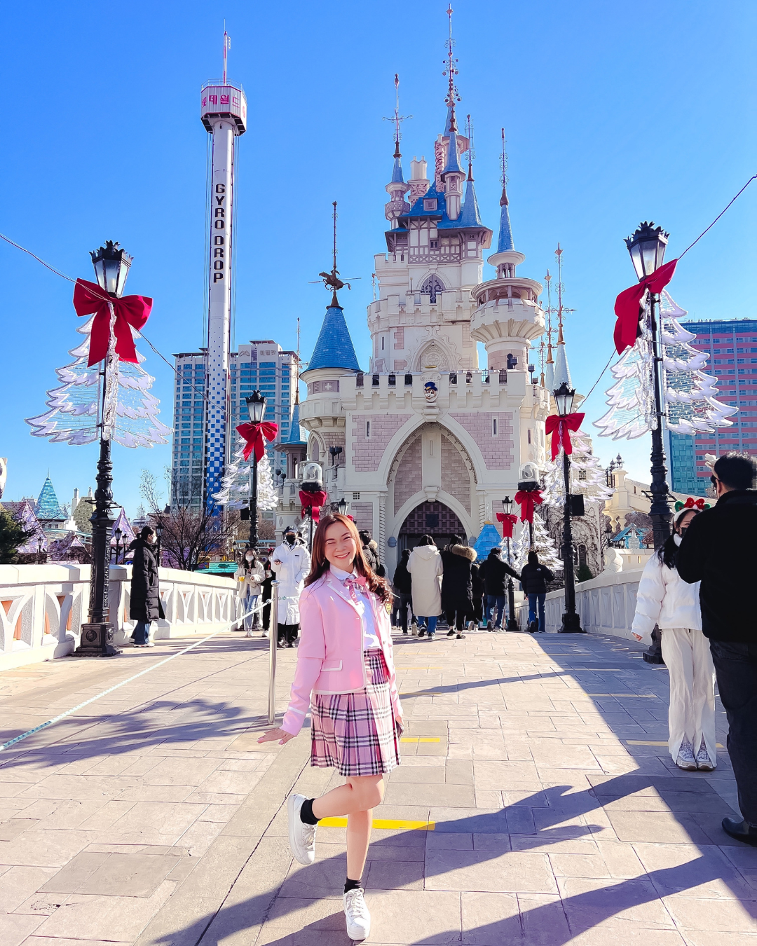 Roxanne Lacap in pink school uniform in front of Lotte World castle Seoul Korea popular kdrama and BTS filming location