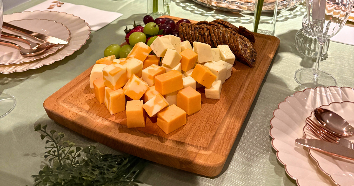 cheese and charcuterie board with grapes and crackers on a spring dinner party table whimsy spring activities Roxanne Lacap Toronto lifestyle creator