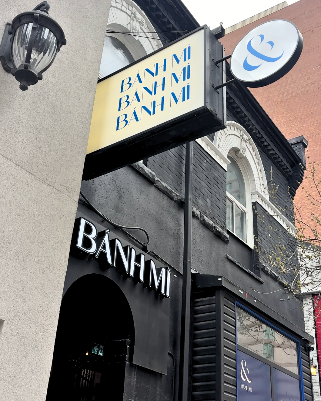 The exterior storefront and outdoor signage of the AndBanhMi shop located in downtown Toronto