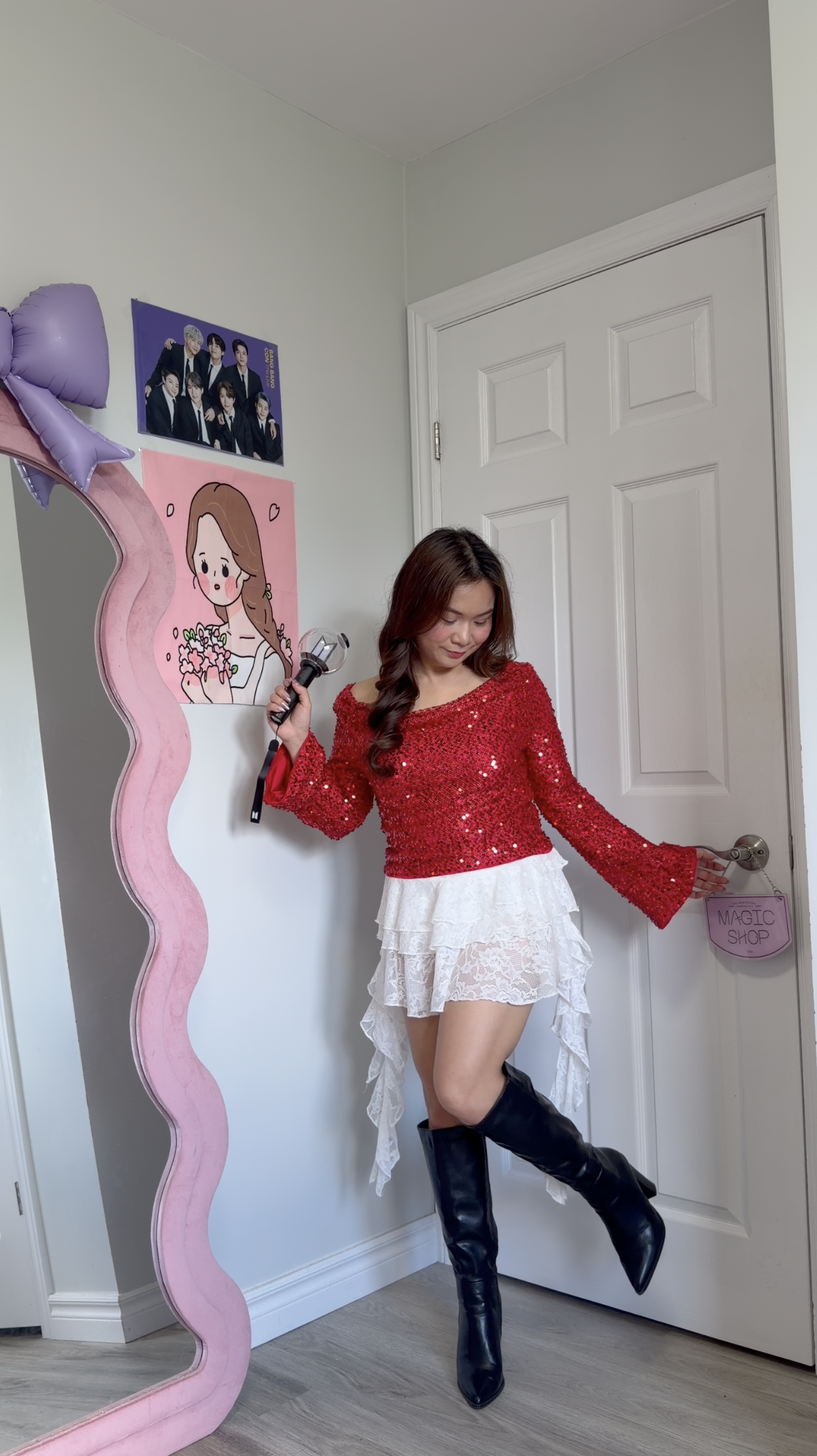 Full body outfit view showing a red sequin top, tiered white lace skirt with asymmetrical drapes, and black knee high boots