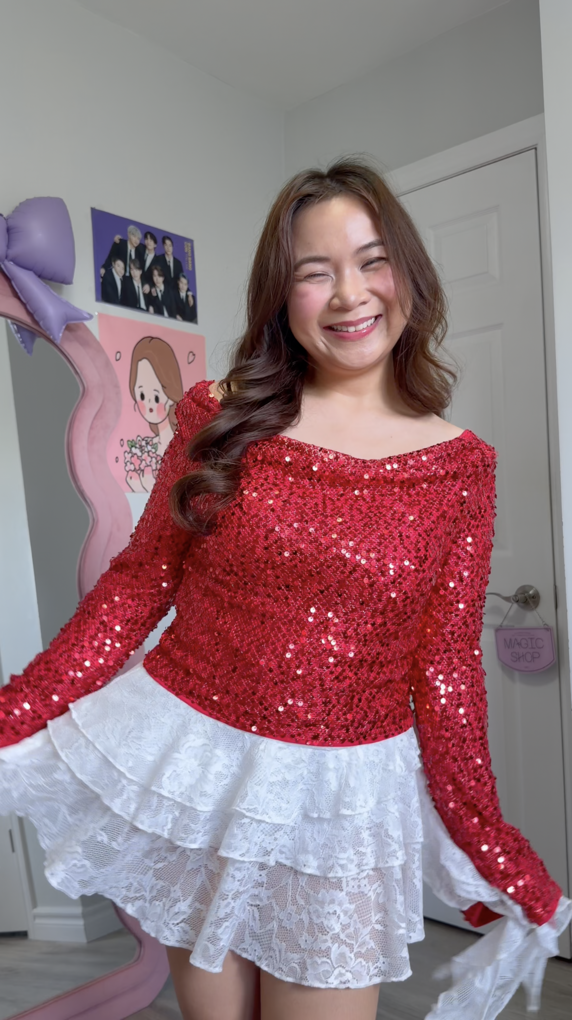 Romantic K-pop concert outfit pairing a bright red sequin top with flared bell sleeves and a layered white lace ruffle skirt.