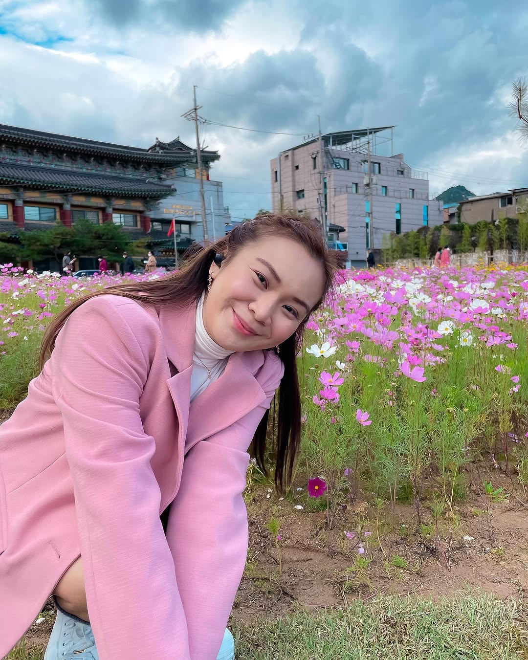 Roxanne Lacap in a pink blazer among cosmos flowers near Bukchon Hanok Village Seoul Korea the BTS RM Namjoon photo spot
