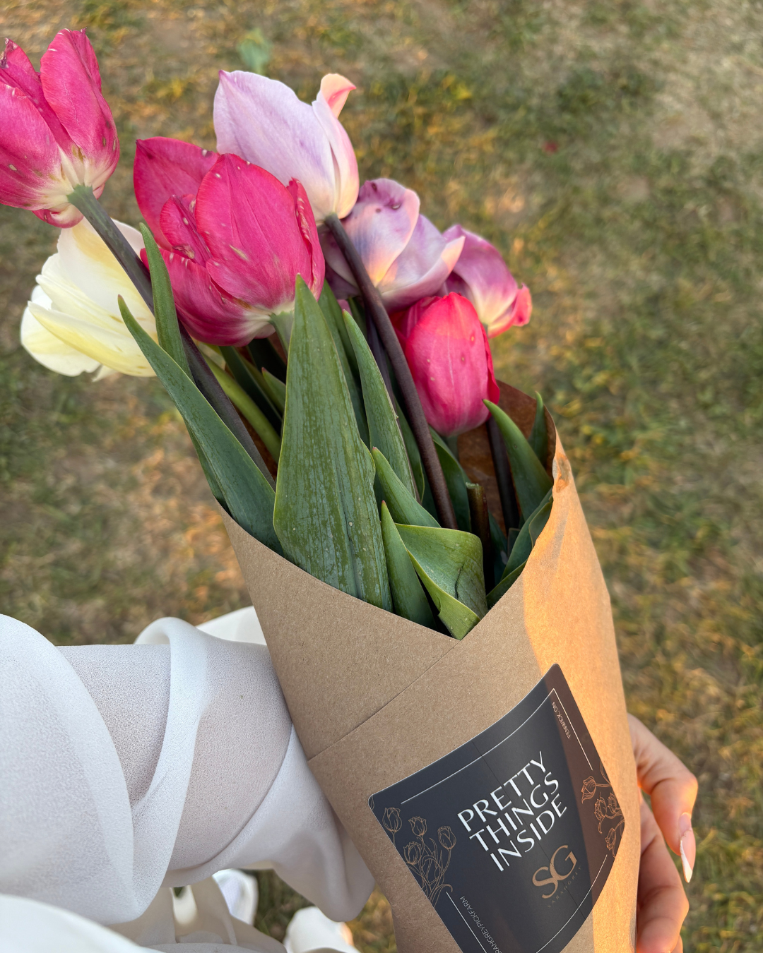 holding a spring tulip bouquet wrapped in kraft paper whimsy spring activities Toronto lifestyle creator Roxanne Lacap