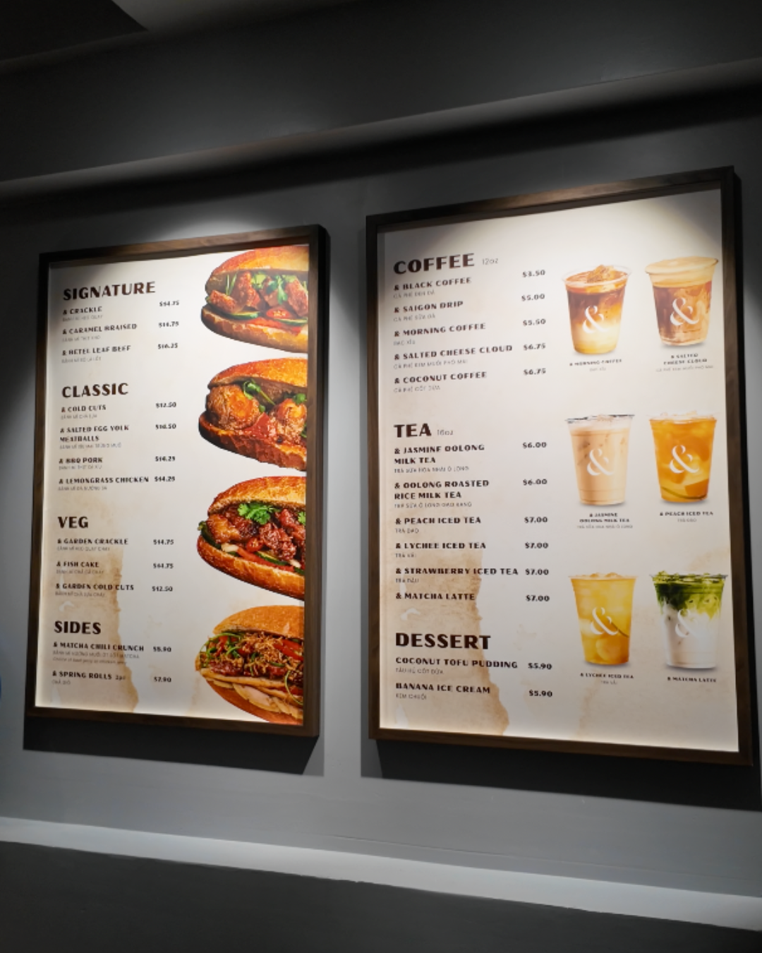 The indoor wall menu at the AndBanhMi shop in Toronto, displaying a variety of banh mi sandwiches, coffees, specialty teas, and desserts with pricing.