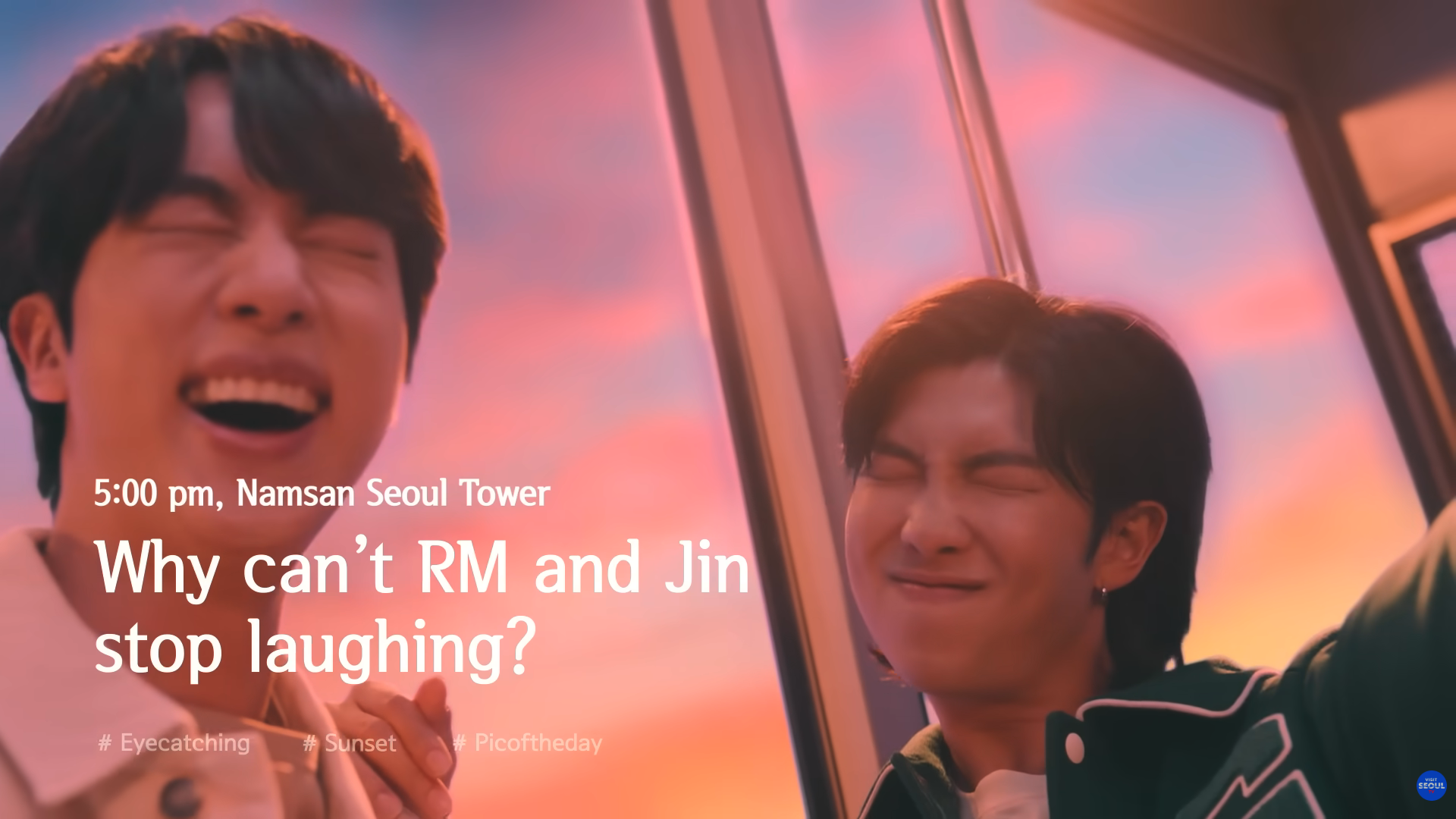 A close-up screenshot of BTS members RM and Jin laughing inside the Namsan Seoul Tower cable car against a vibrant pink and orange sunset sky. The image features a teaser text layout from their official snapshotSeoul tourism campaign video, perfect for a bonus spot recommendation in a BTS Seoul itinerary.