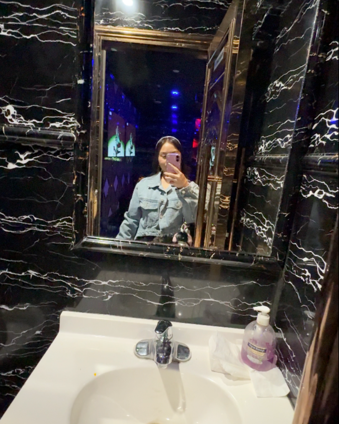 A mirror selfie showcasing the premium black and white marble design of the private bathroom inside a luxury singing lounge at ET KTV Karaoke Markham Toronto